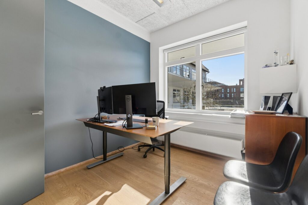 Moderne kontormiljø i Kirkebjerg Vigespor med lyse arbejdsrum og bevarede industrielle detaljer.